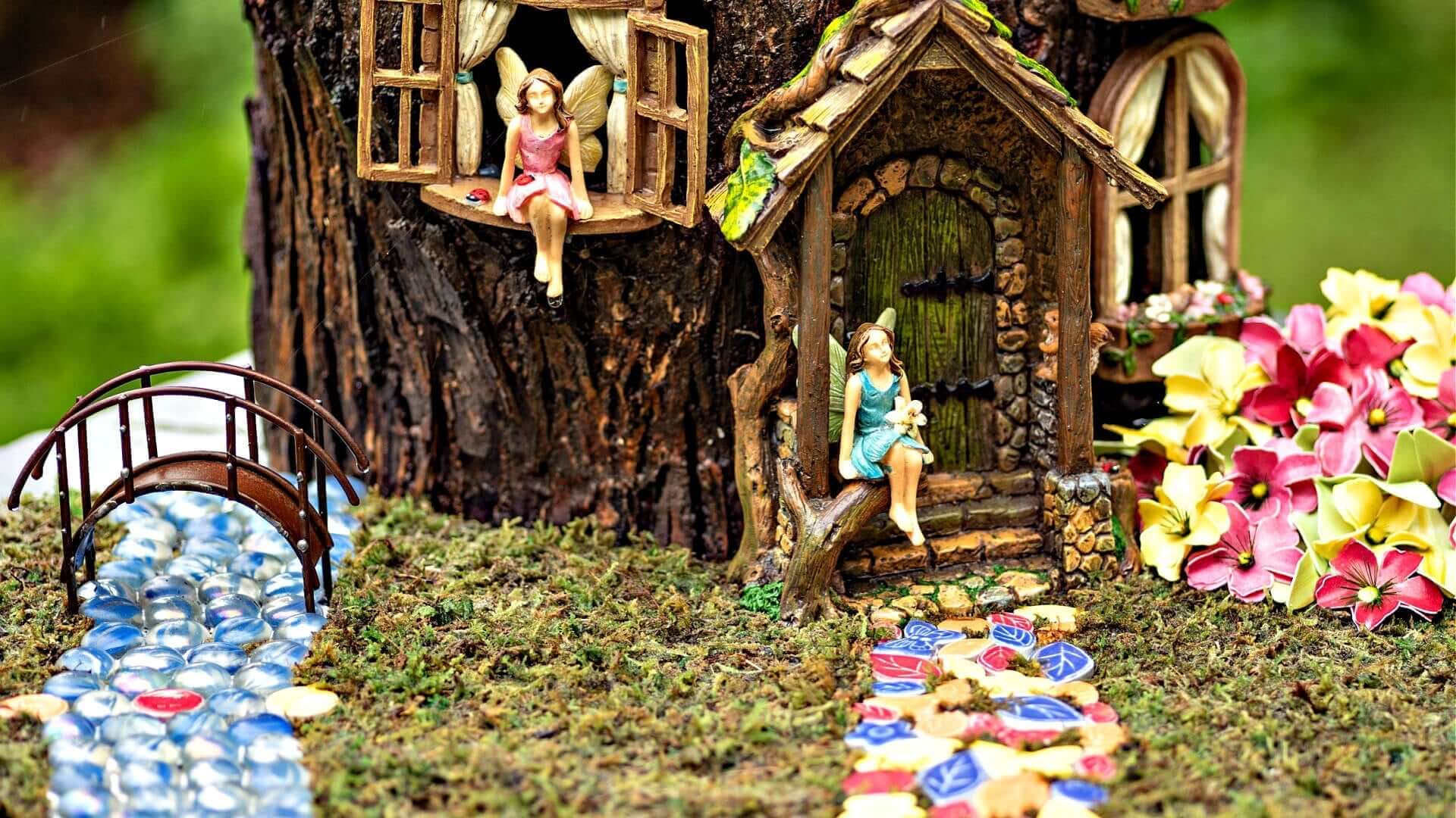 Miniature fairy house with rustic wood, stone, moss garden accents