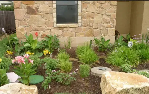 Round flat solar-powered garden light with dark gray top and metal base for drought-hardy plants.